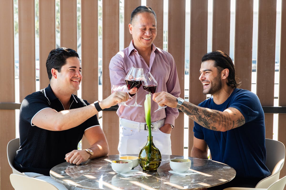 Lance McCullers et al. sitting at a table with a glass of wine