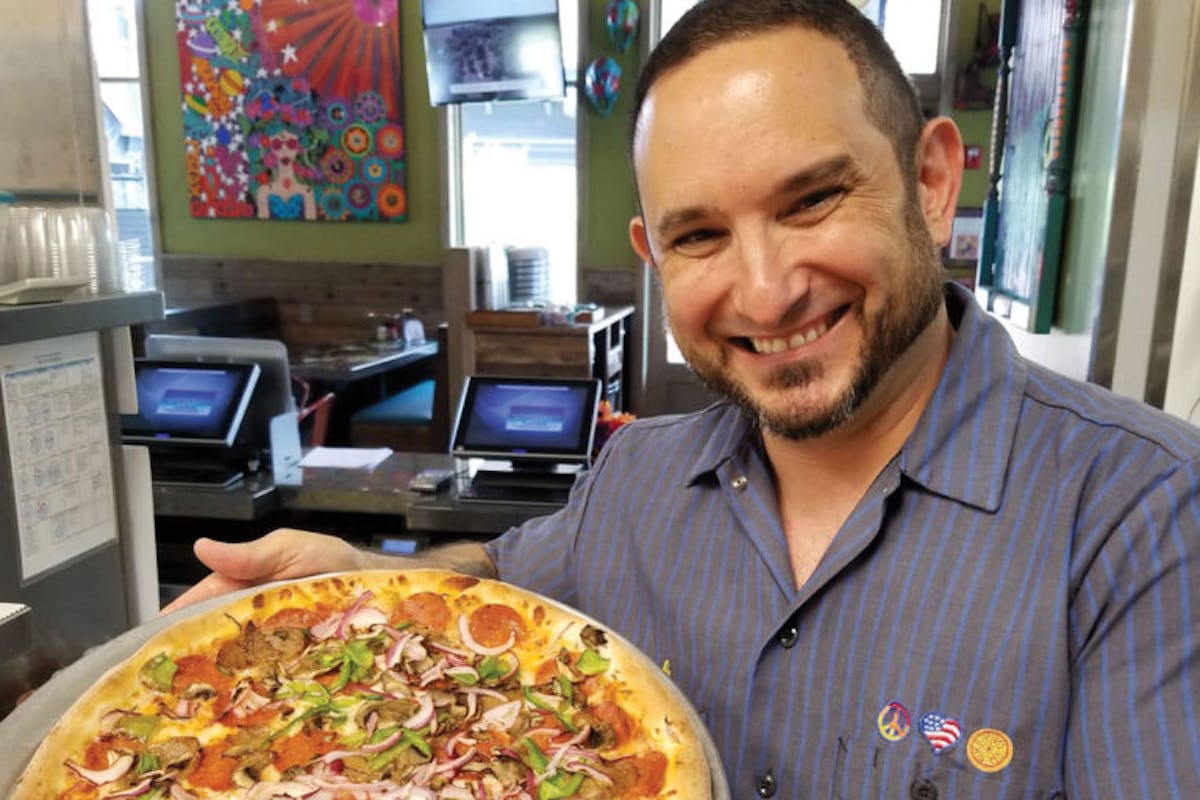 a person holding a pizza