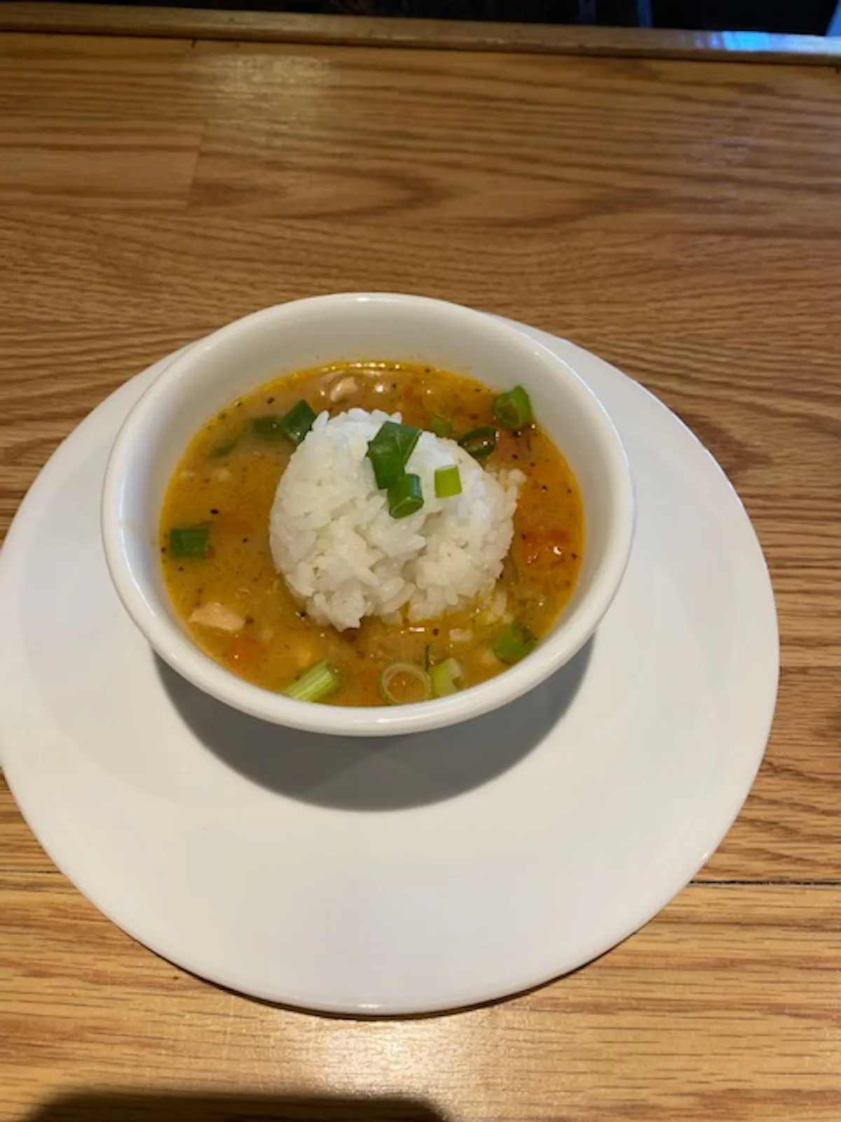 a bowl of food on a plate on a table