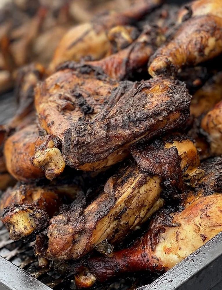 a pile of cooked meat on a grill