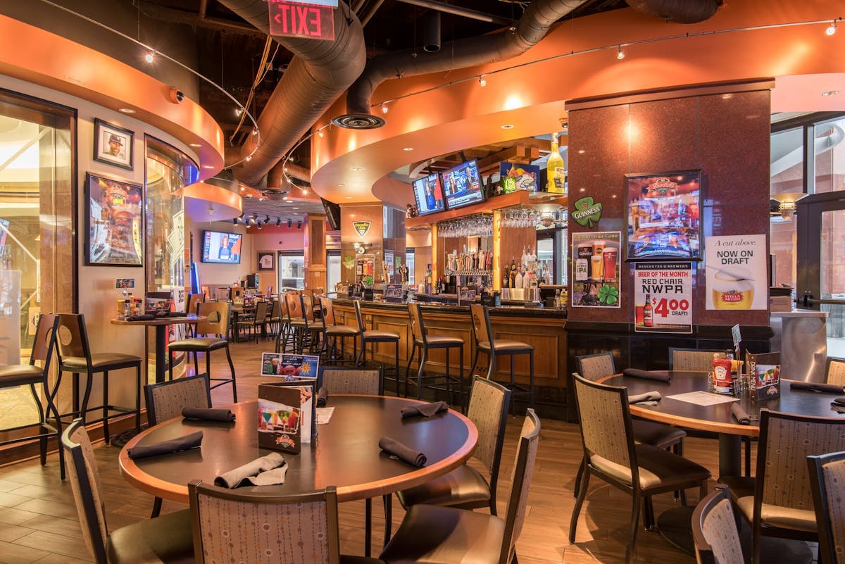 a large room with a bar counter and tables