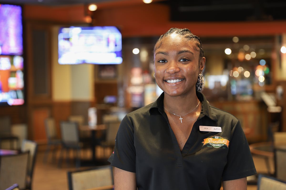 a person standing in front of a restaurant