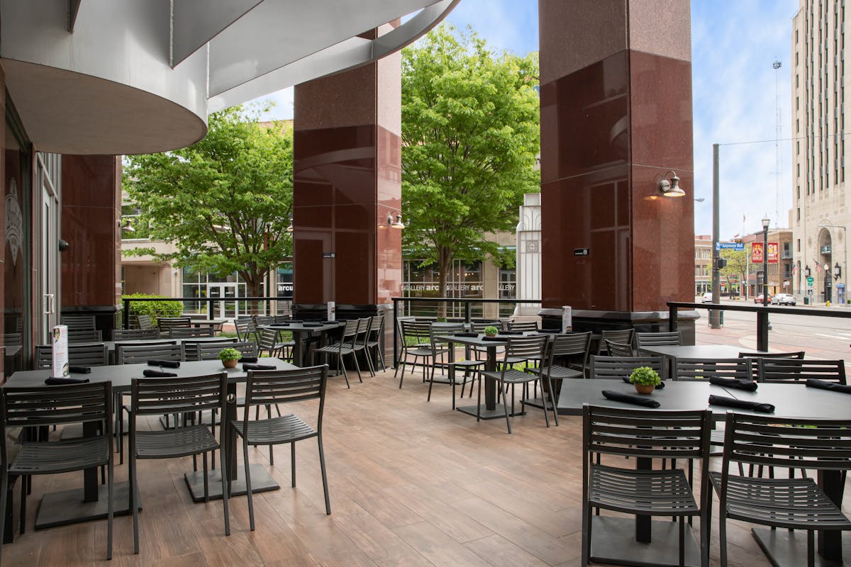 an open space patio with tables and chairs