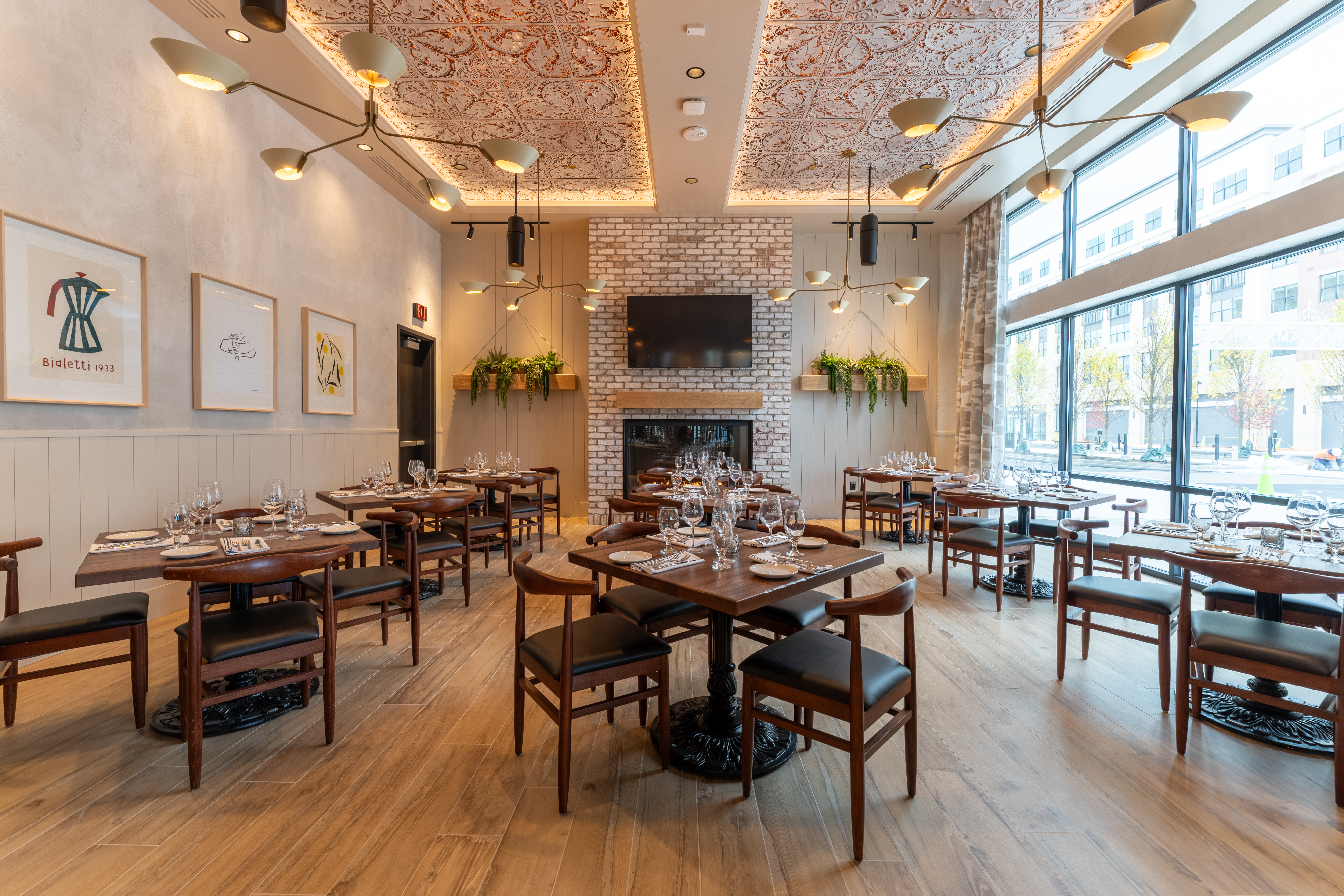 a room with tables and chairs and a fireplace