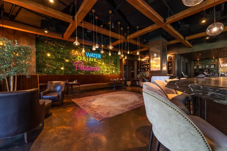 a room with chairs and a wall with lights