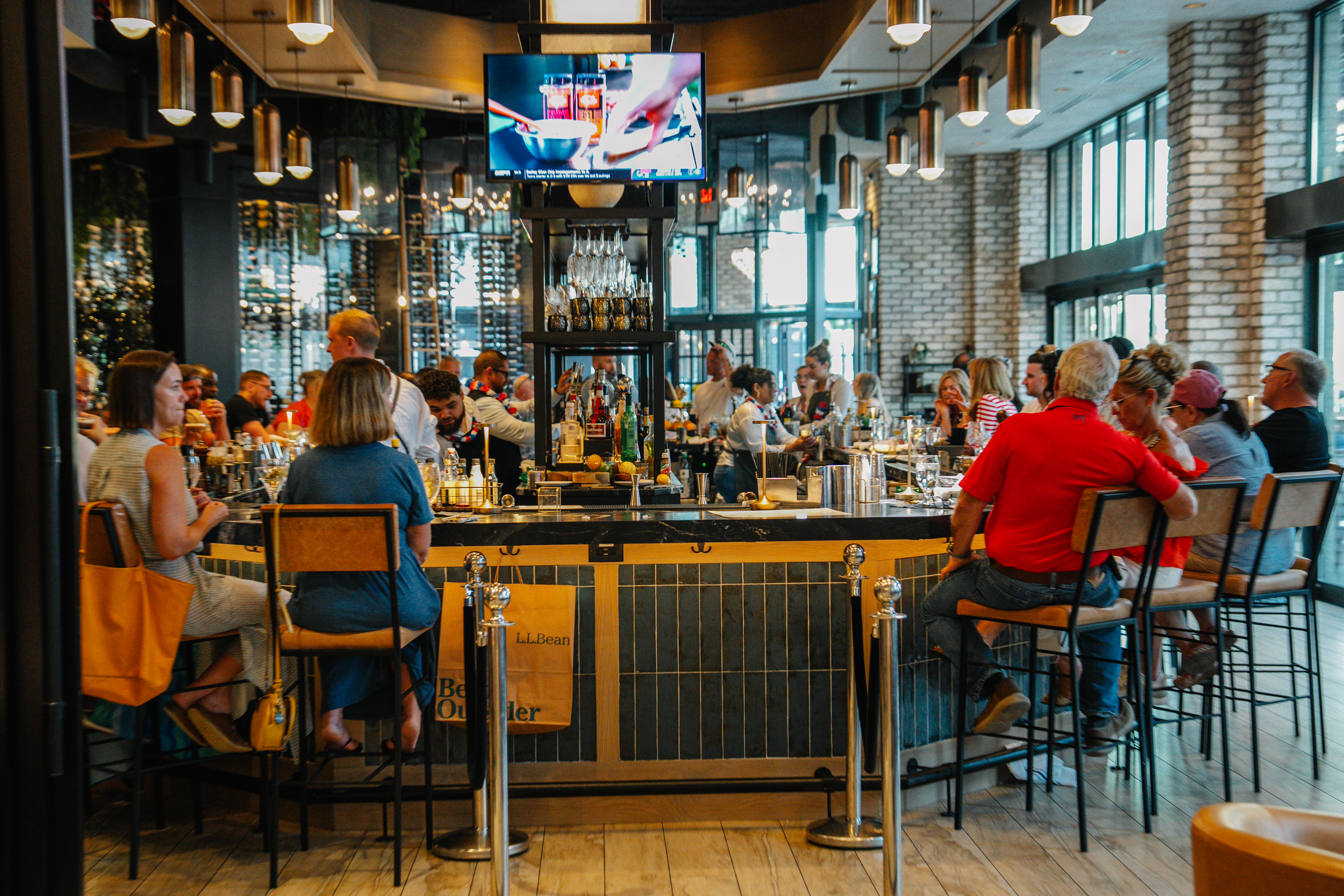a group of people sitting at a bar