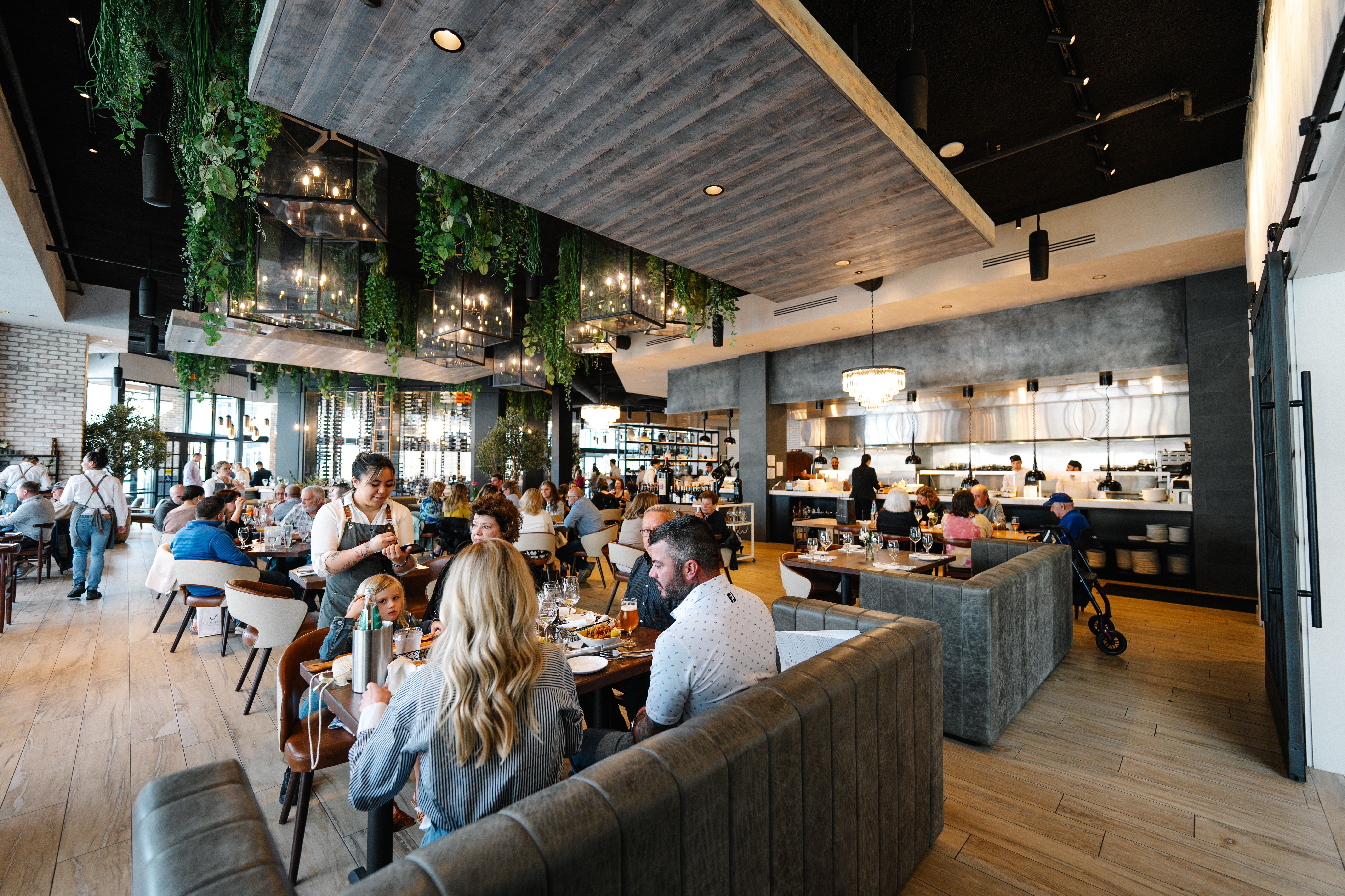 a group of people sitting at tables in a restaurant