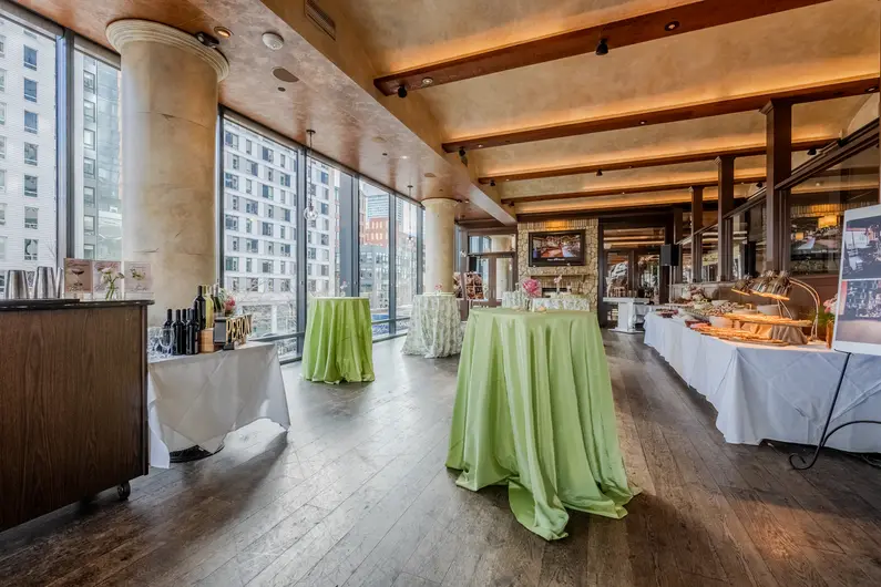 a room with tables covered in green cloths
