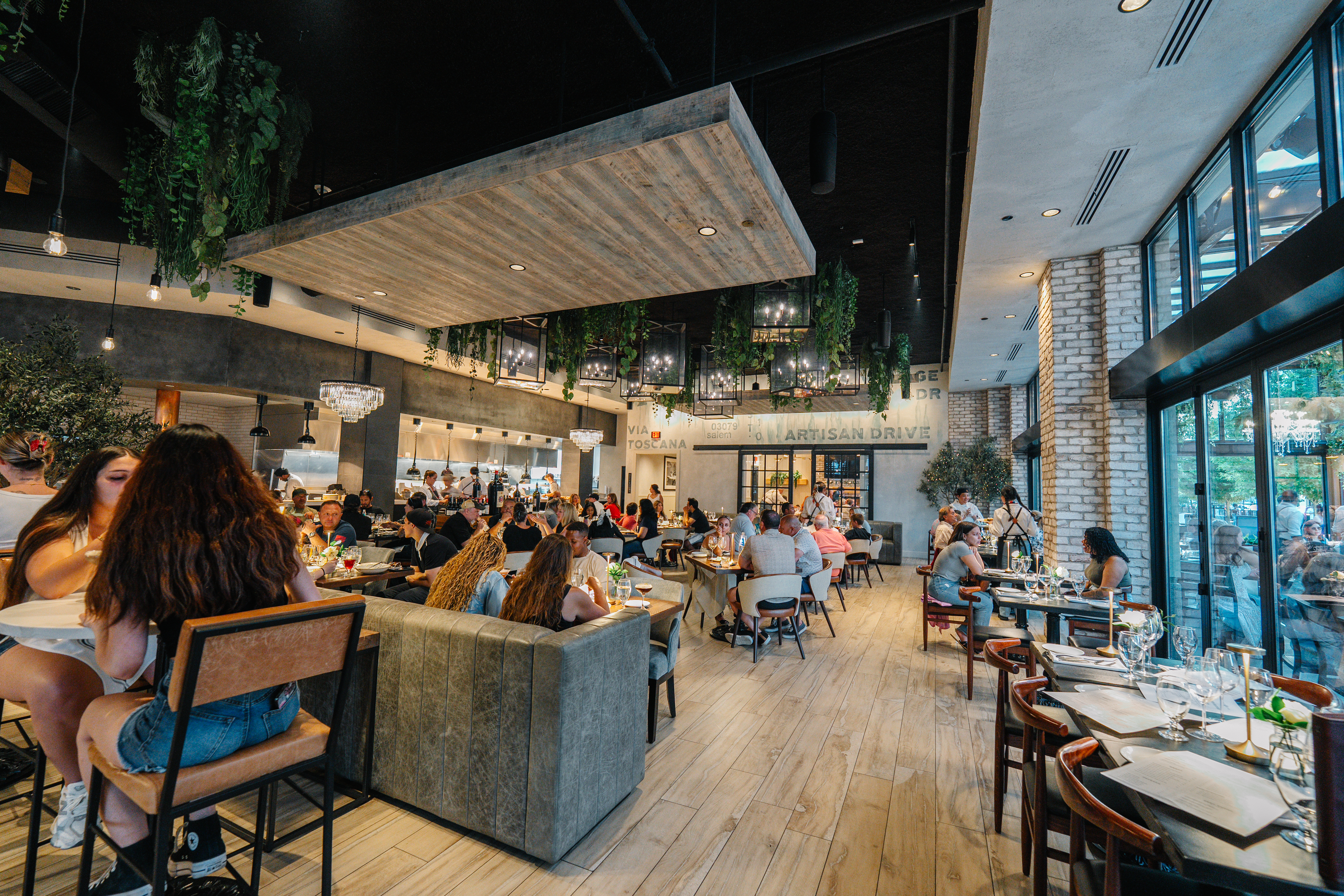 a large room with tables and chairs and people sitting at tables