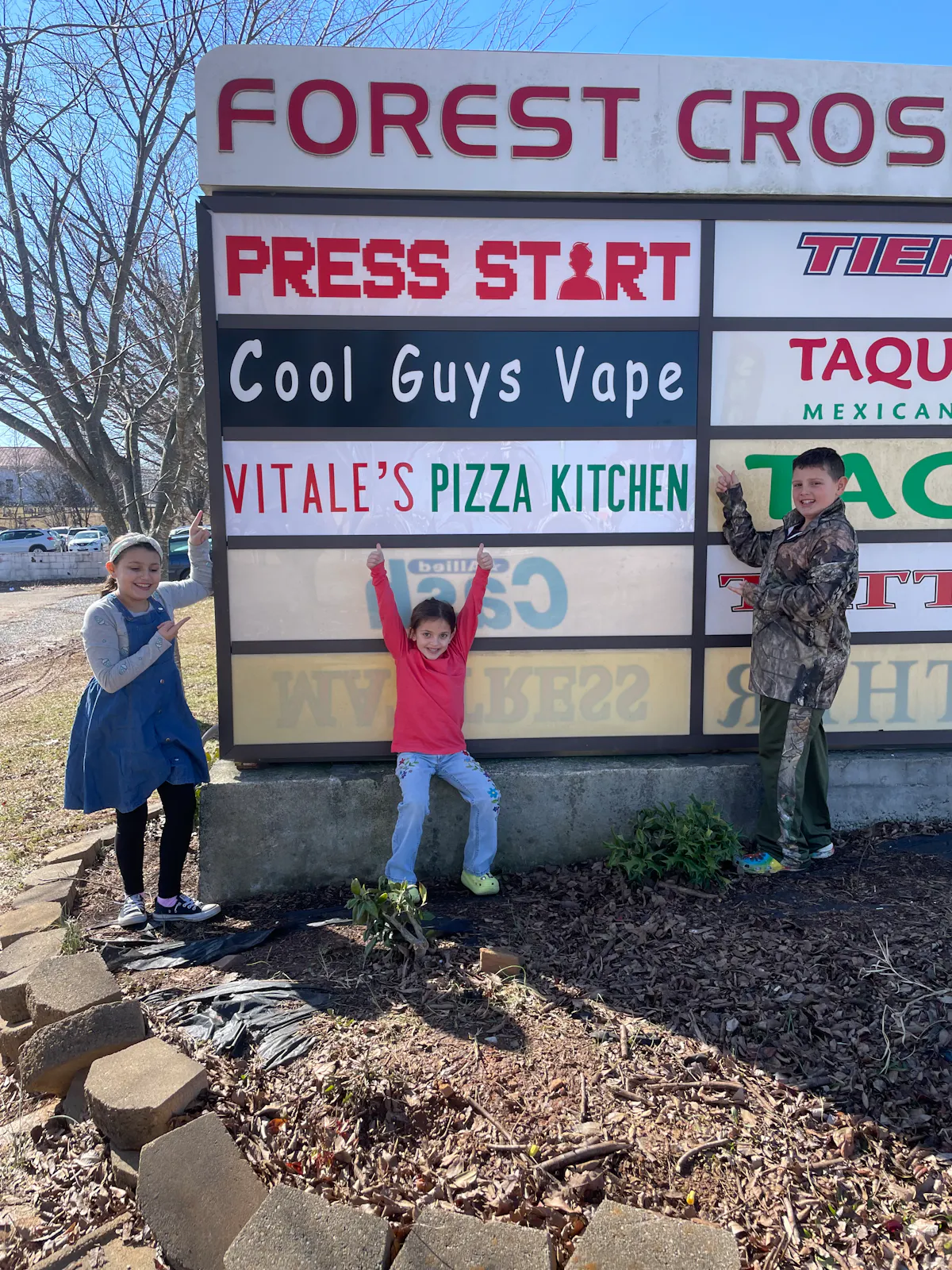 a group of people standing in front of a sign
