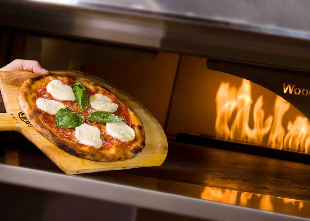 a pizza sitting on top of an oven