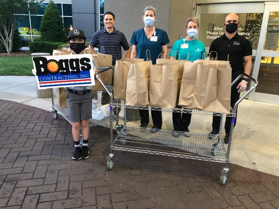 a group of people standing around a table