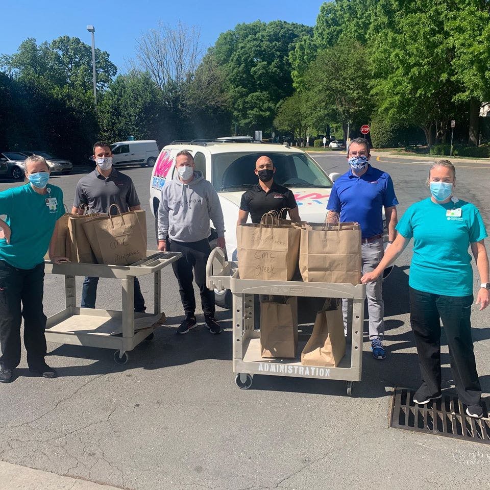 a group of people standing in front of a truck
