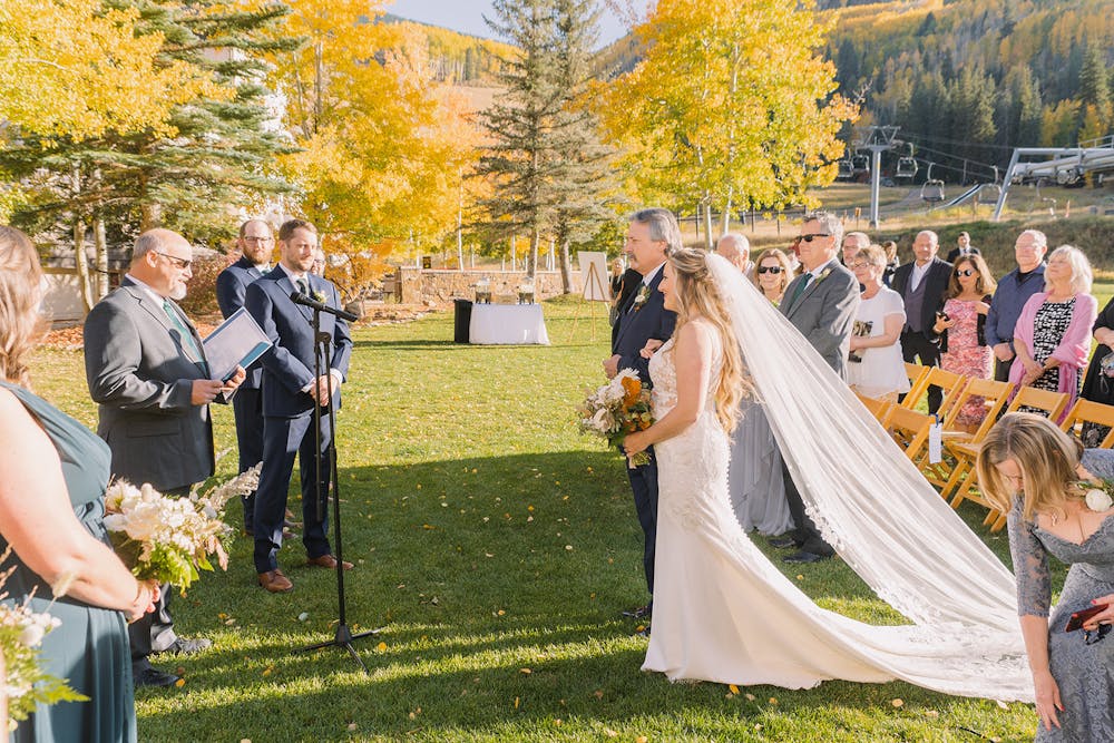 a group of people that are standing in the grass