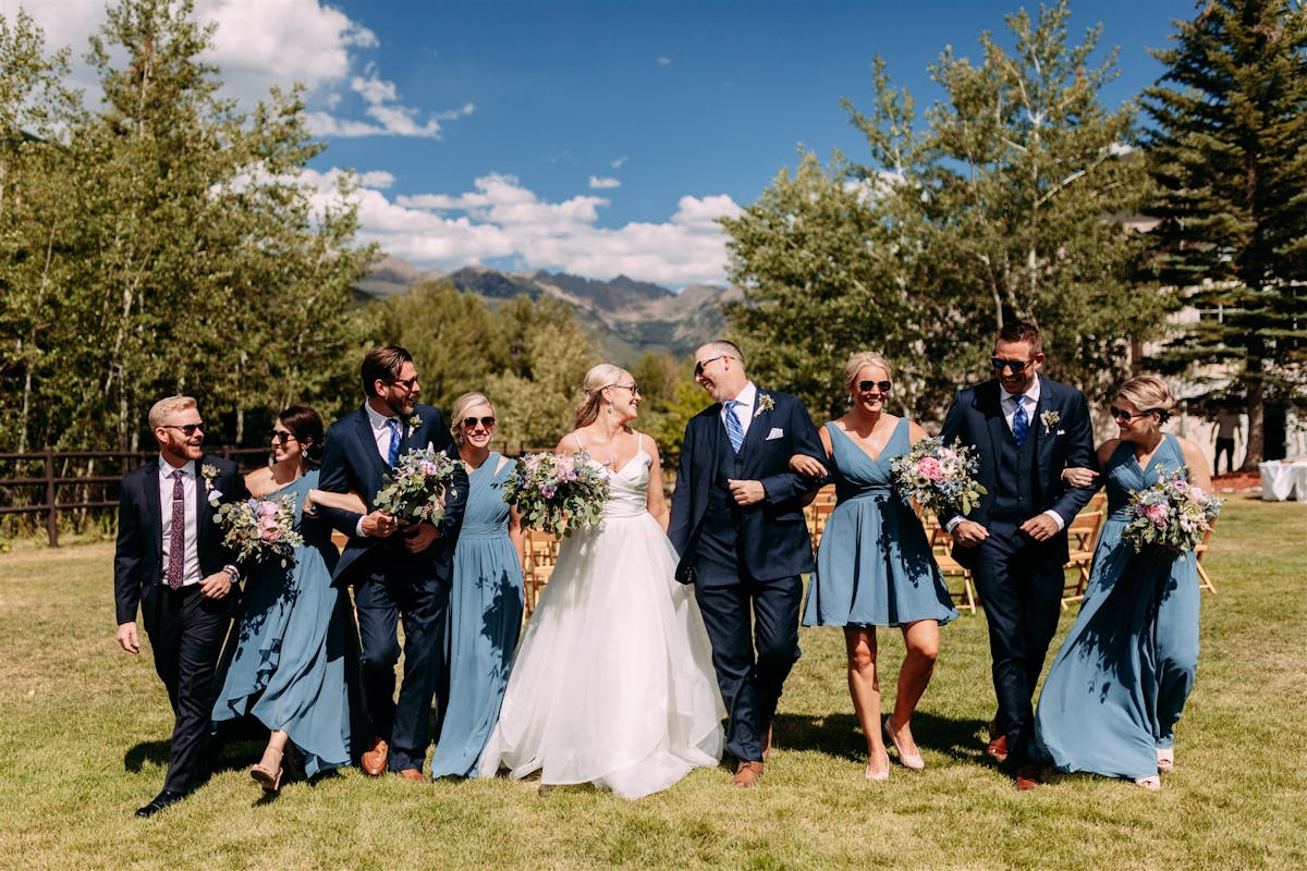 Larkspur Wedding Venue Vail Colorado Mountain Wedding a group of people standing in the grass