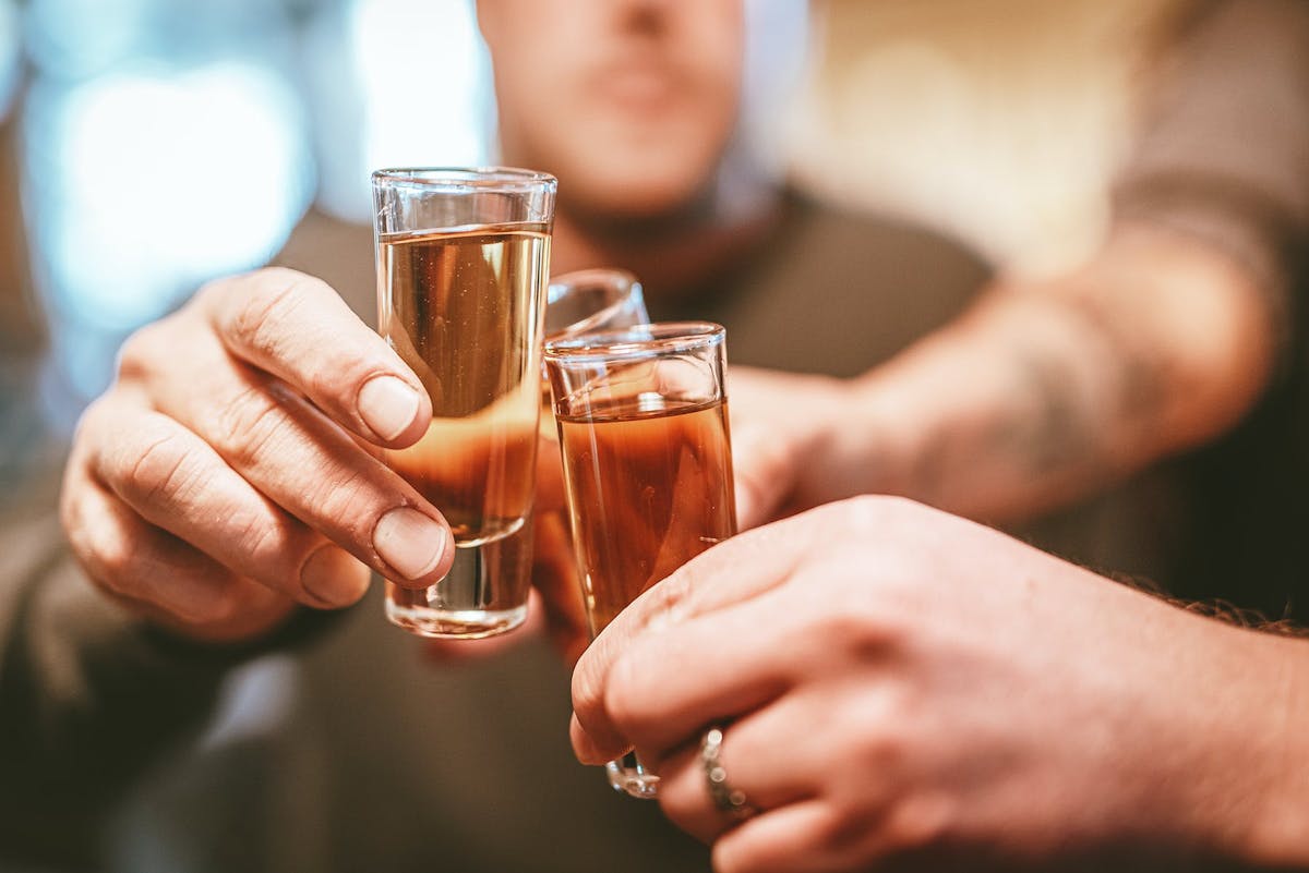 a hand holding a glass of wine