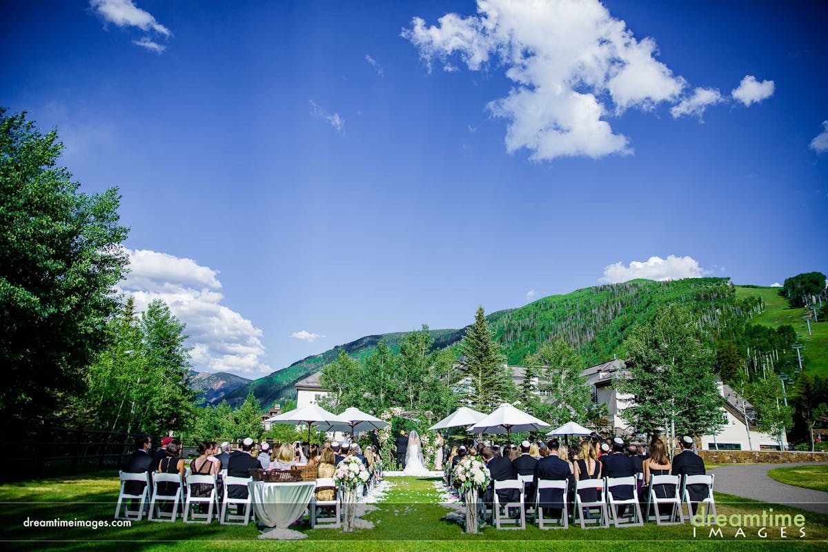 a gLarkspur Wedding Venue Vail Colorado Mountain Rehearsal, Welcome Reception Mountainside Patio Outdoor Reception Ceremony Lawnroup of people sitting at a park