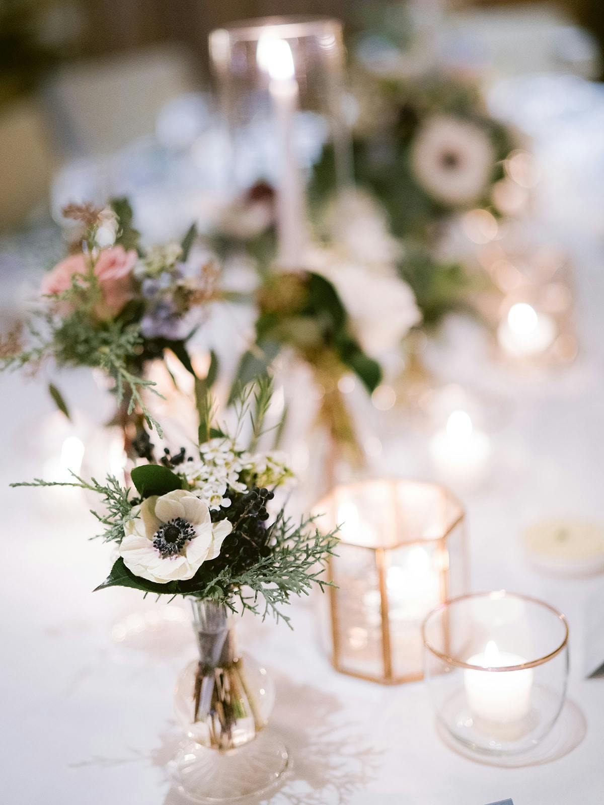 a vaseLarkspur Vail Winter Wedding Venue Colorado Table Decor of flowers on a table