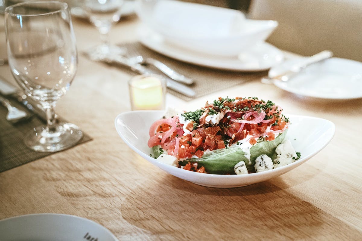 a plate of food and glasses of wine on a table