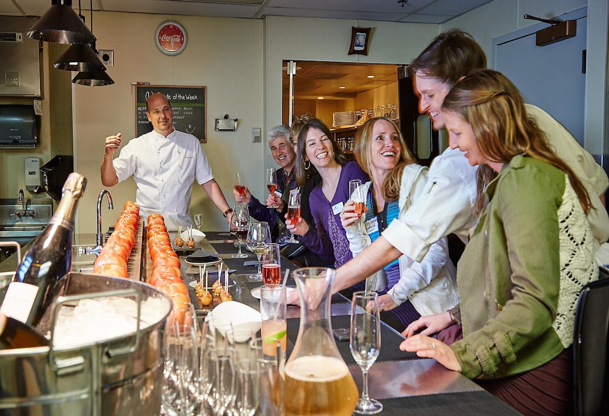 a group of people preparing food in a kitchen