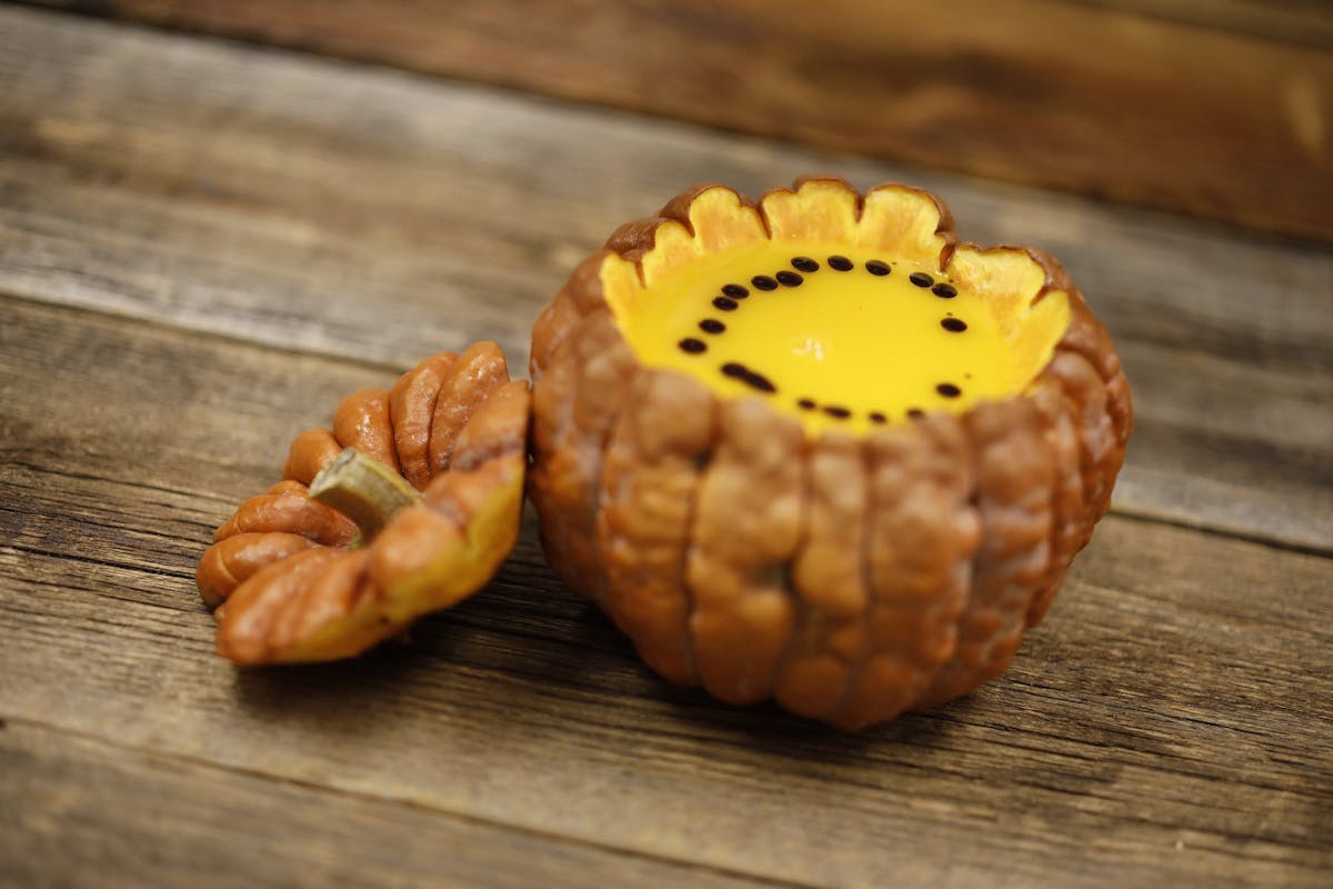 a close up of a doughnut sitting on top of a wooden cutting board