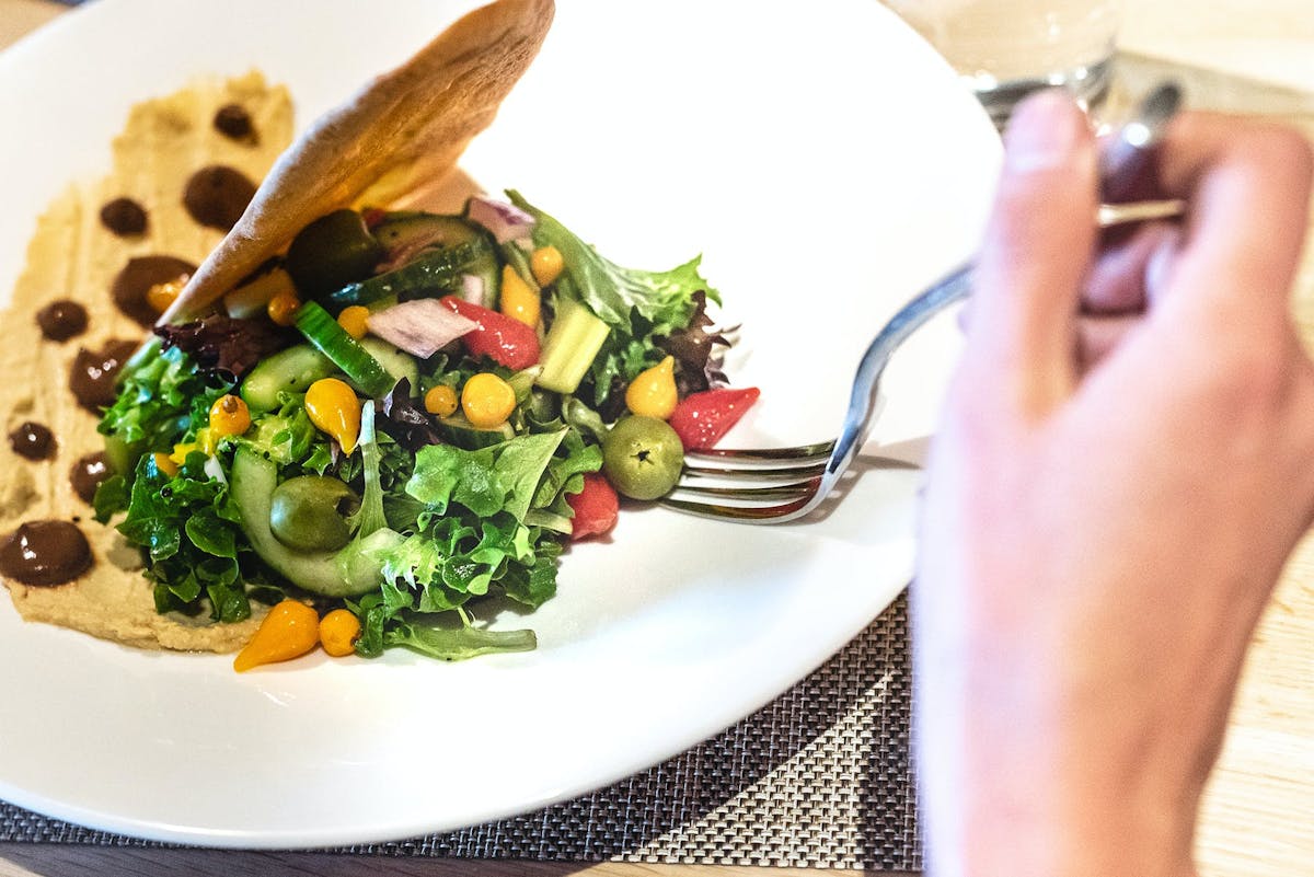 a person holding a plate of food