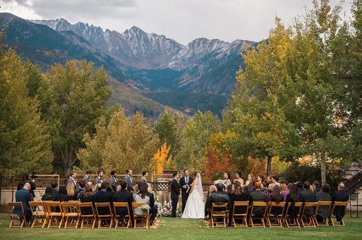 a grouLarkspur Wedding Venue Vail Colorado Mountain Rehearsal, Welcome Reception Mountainside Patio Outdoor Reception Ceremony Lawnp of people riding on the back of a horse drawn carriage