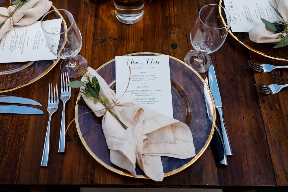 a wooden table topped with plates of food on a plate