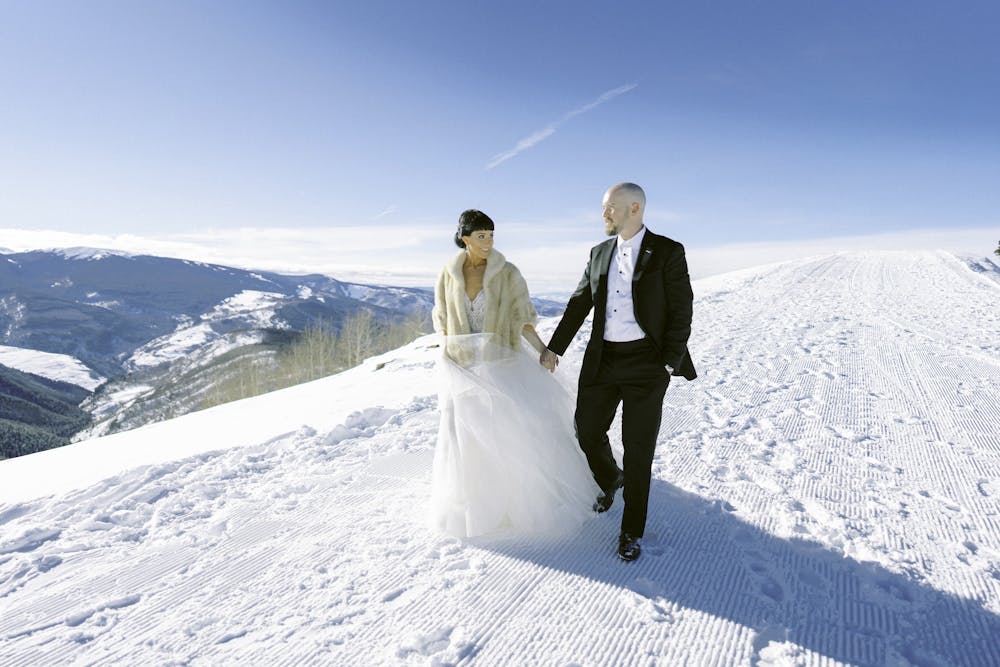 a man standing on top of a snow covered slope