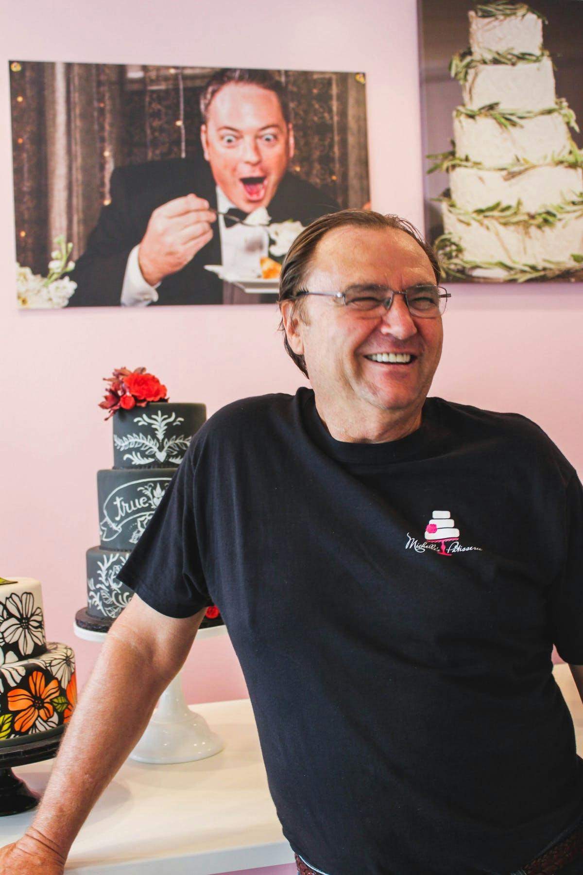 a man wearing glasses and smiling at the camera