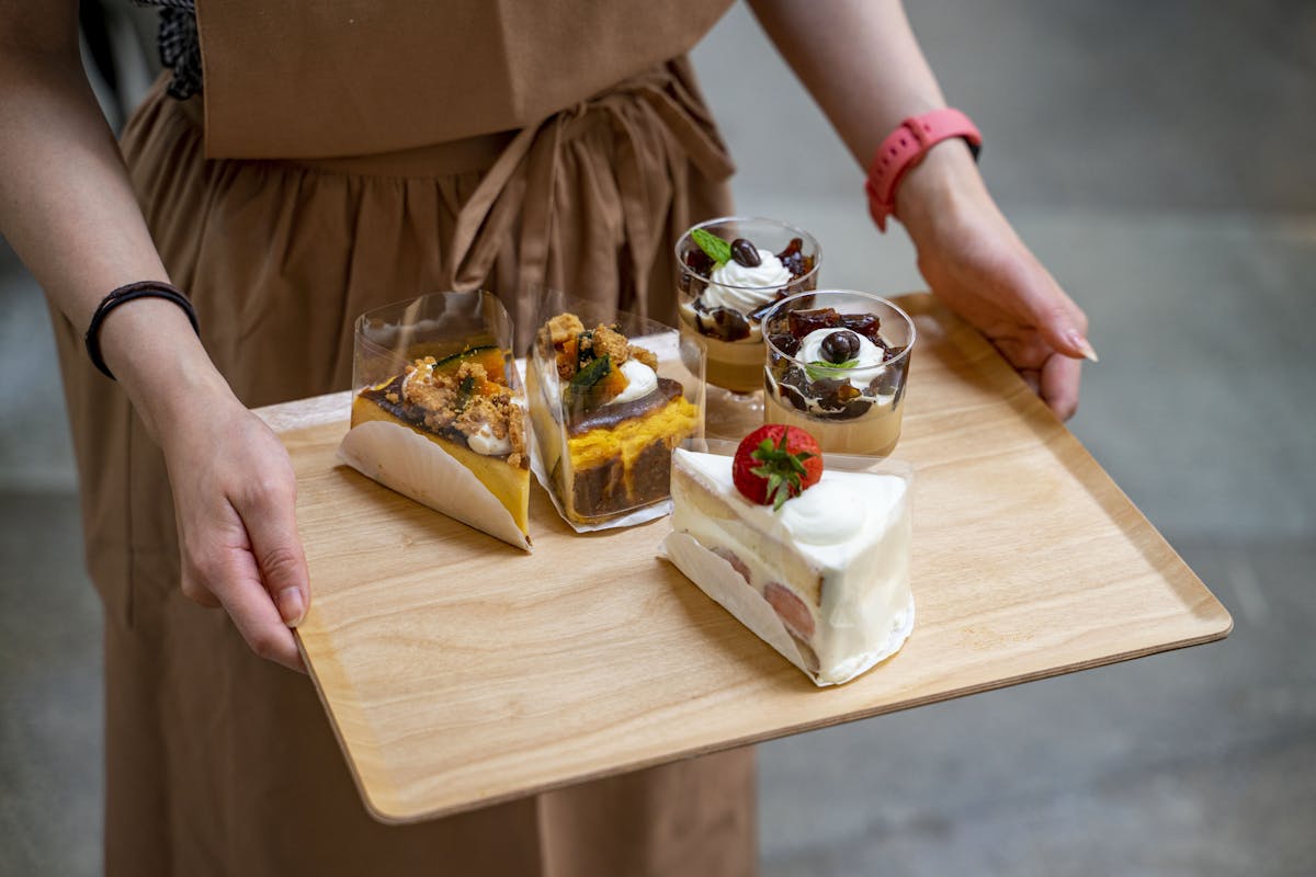 a wooden cutting board with a cake on a table