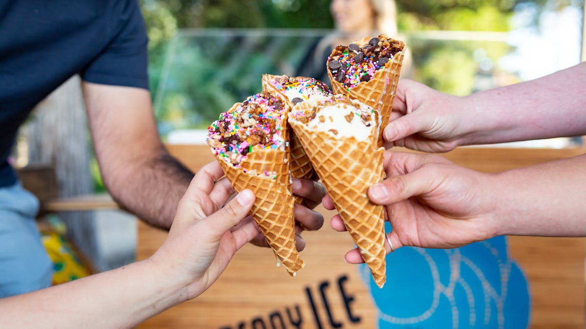 a hand holding an ice cream cone