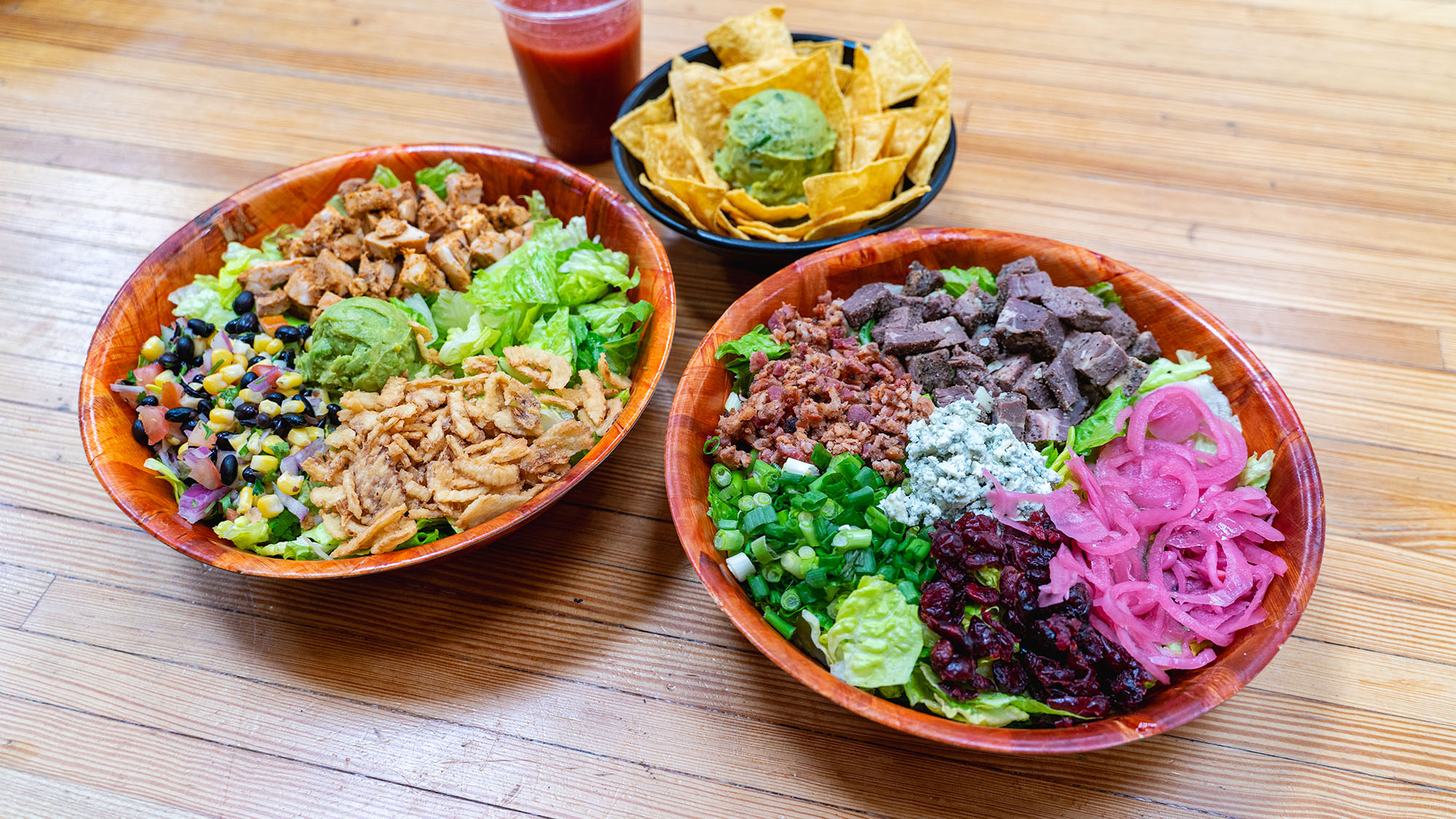 a variety of salads, chips and guacamole