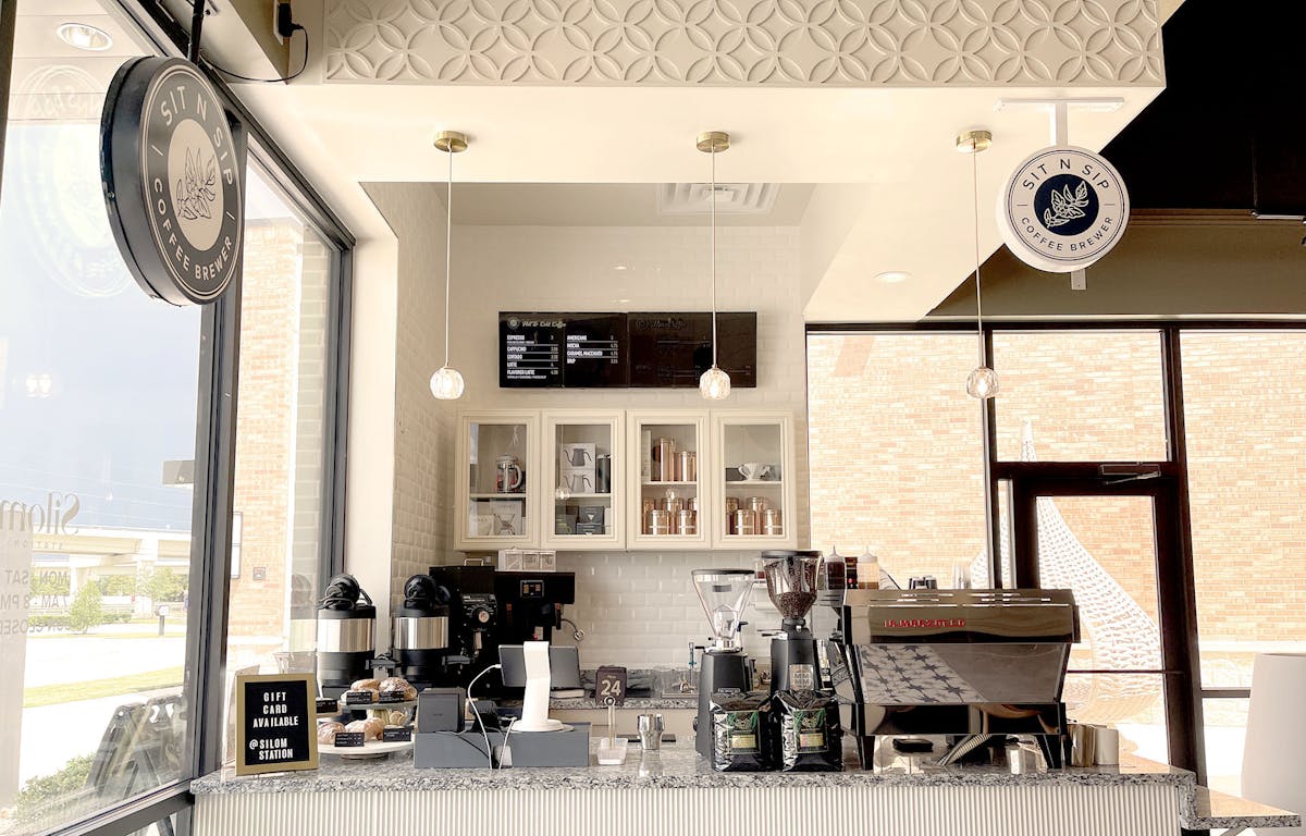 a kitchen with a clock at the top of a table