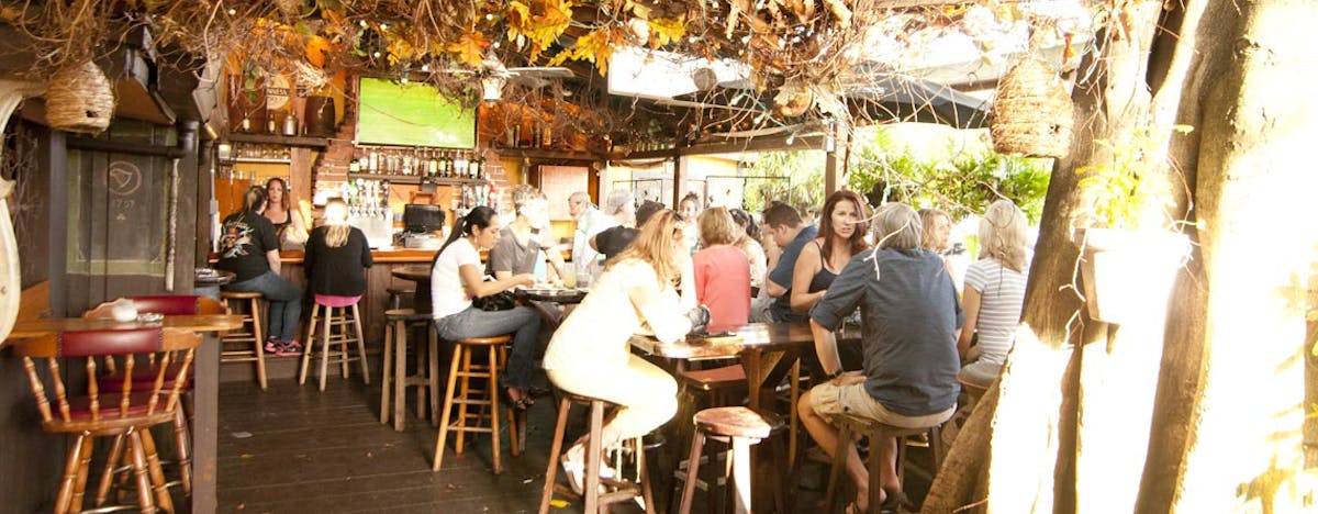 a group of people sitting at a table in a outdoor patio