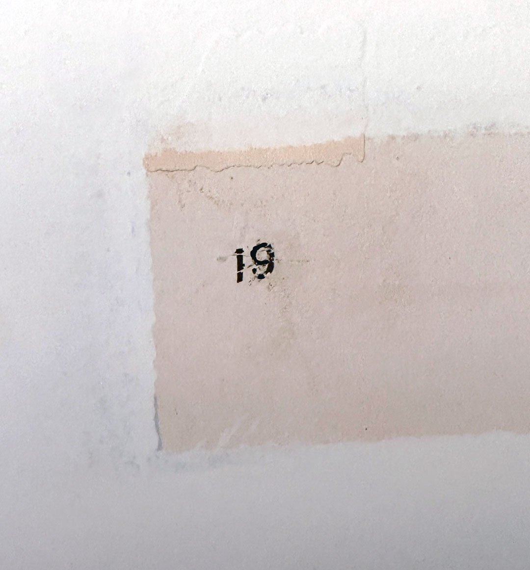 A number 19 etched on a wall