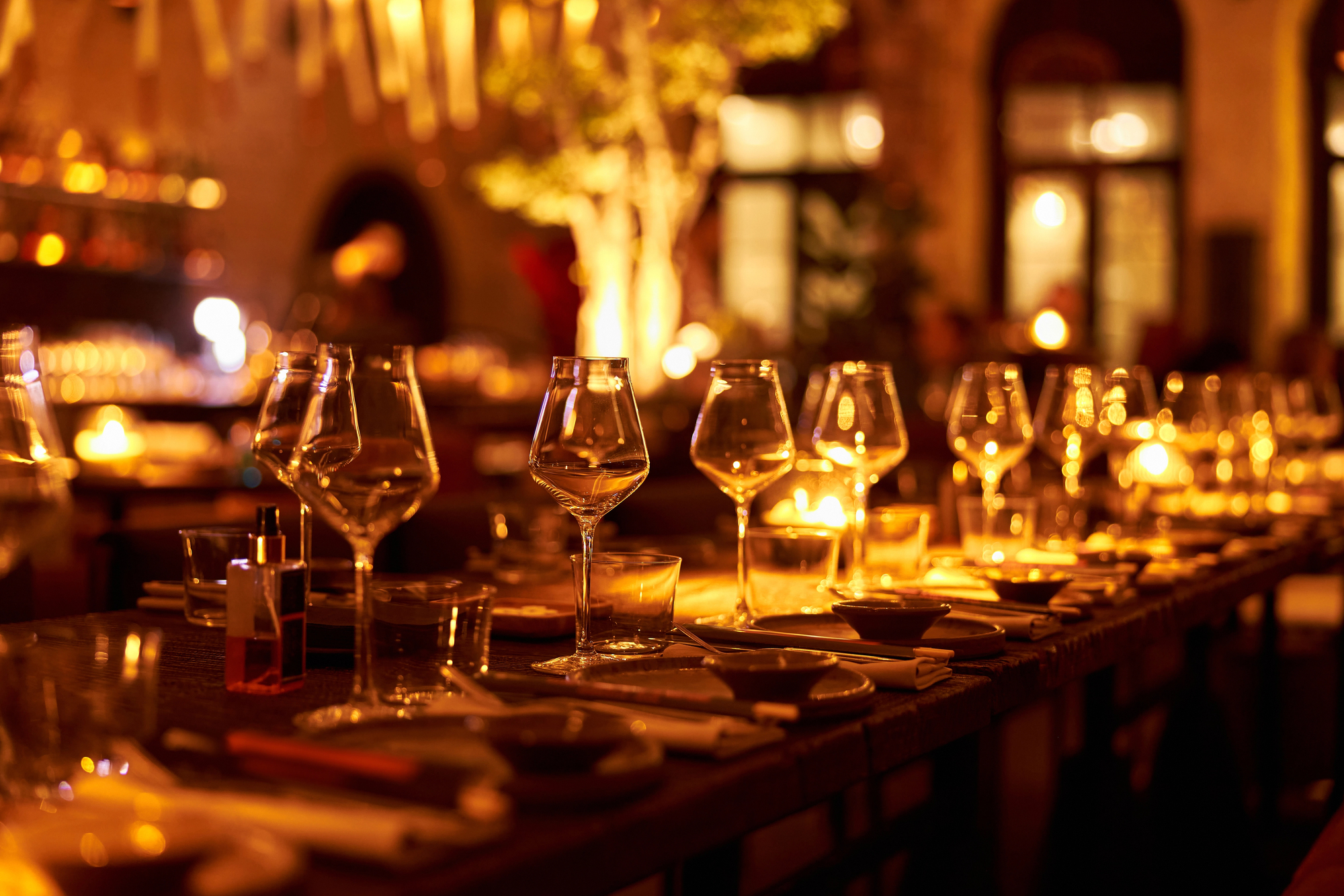 a table with wine glasses and candles