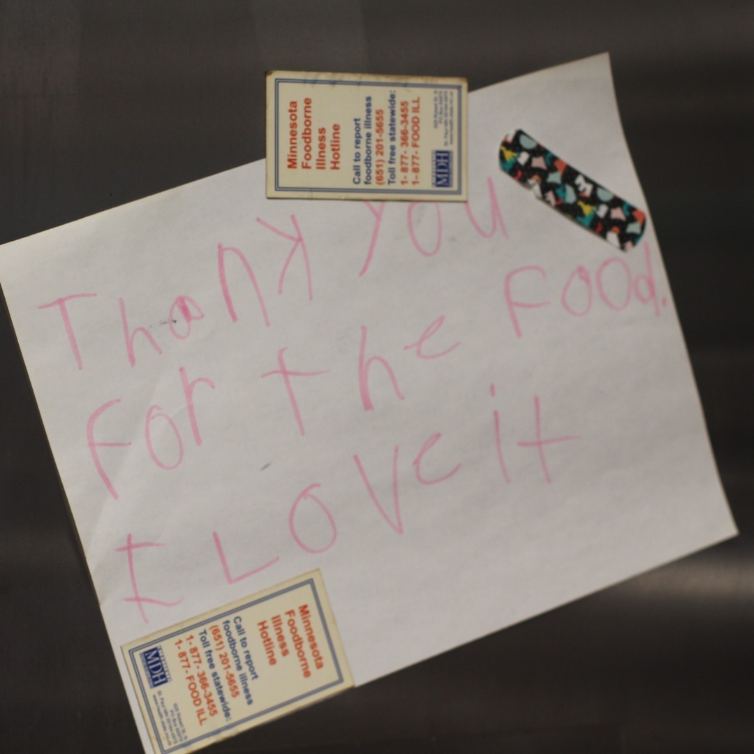 a white paper with pink writing on it