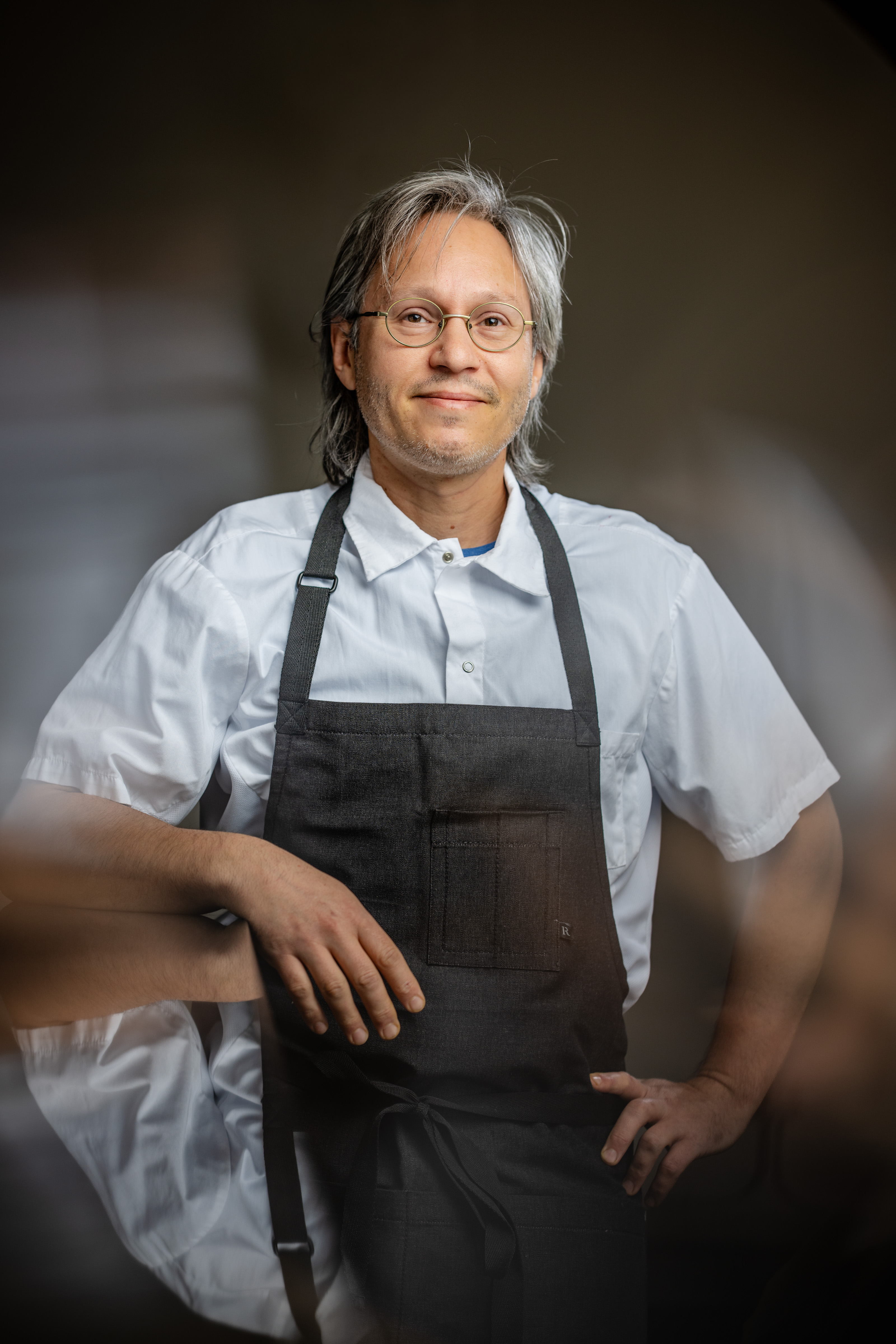 a man wearing a black apron