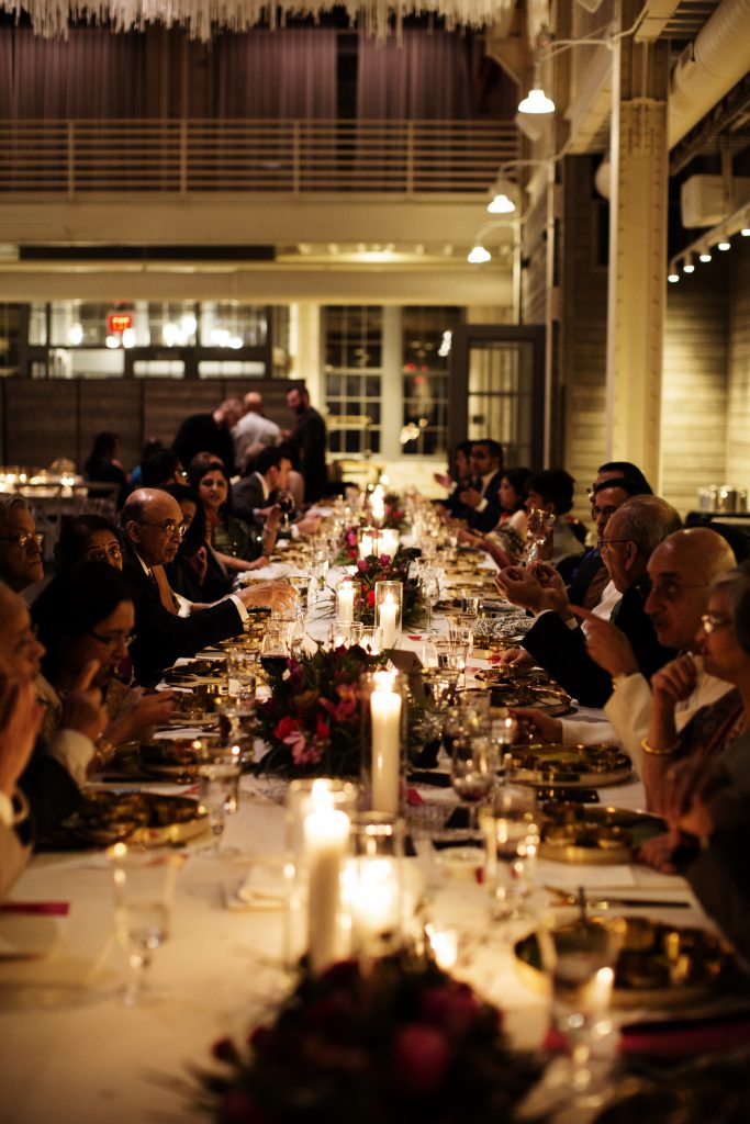 a group of people sitting at a long table