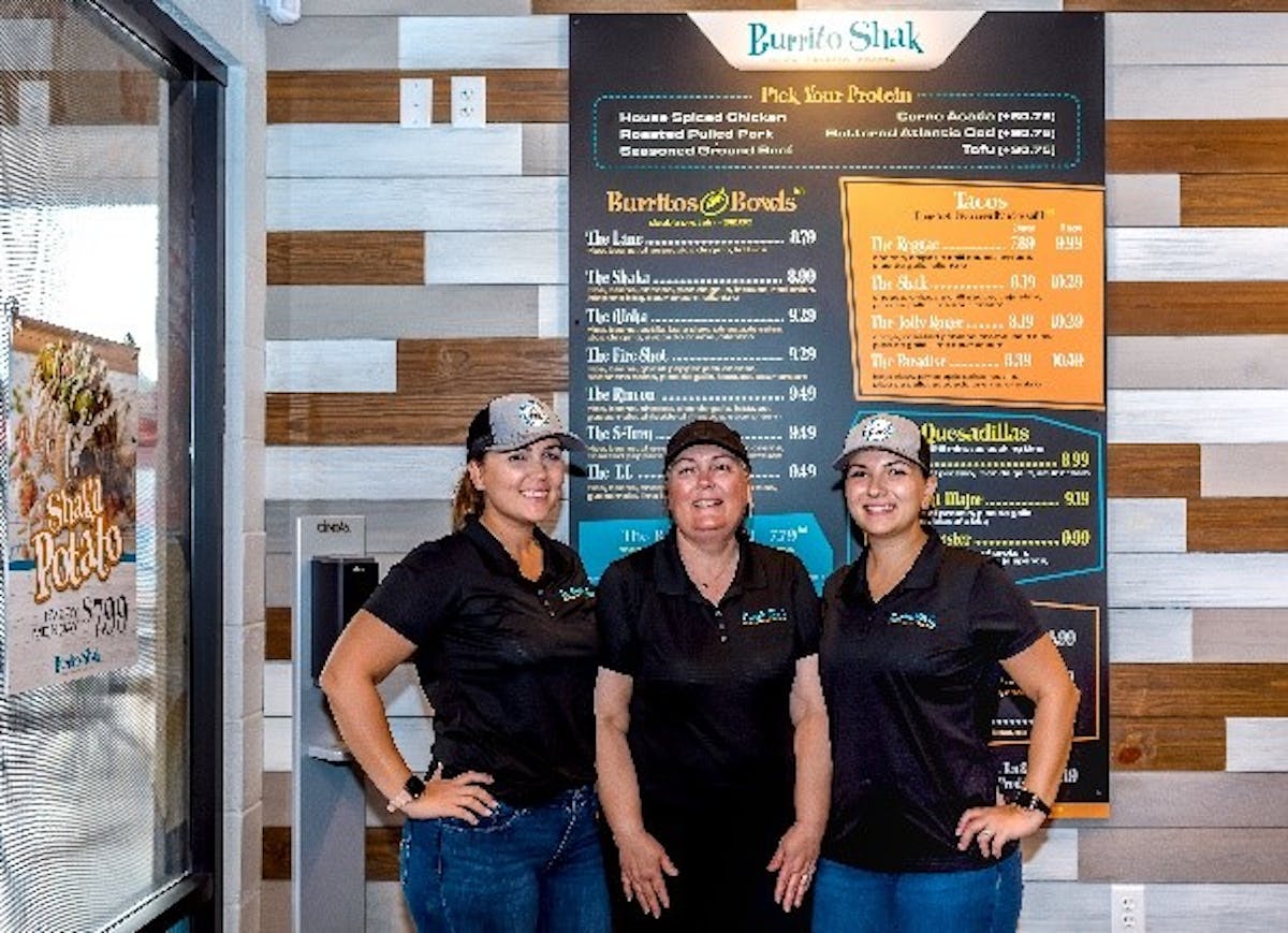 a group of people standing in front of a store