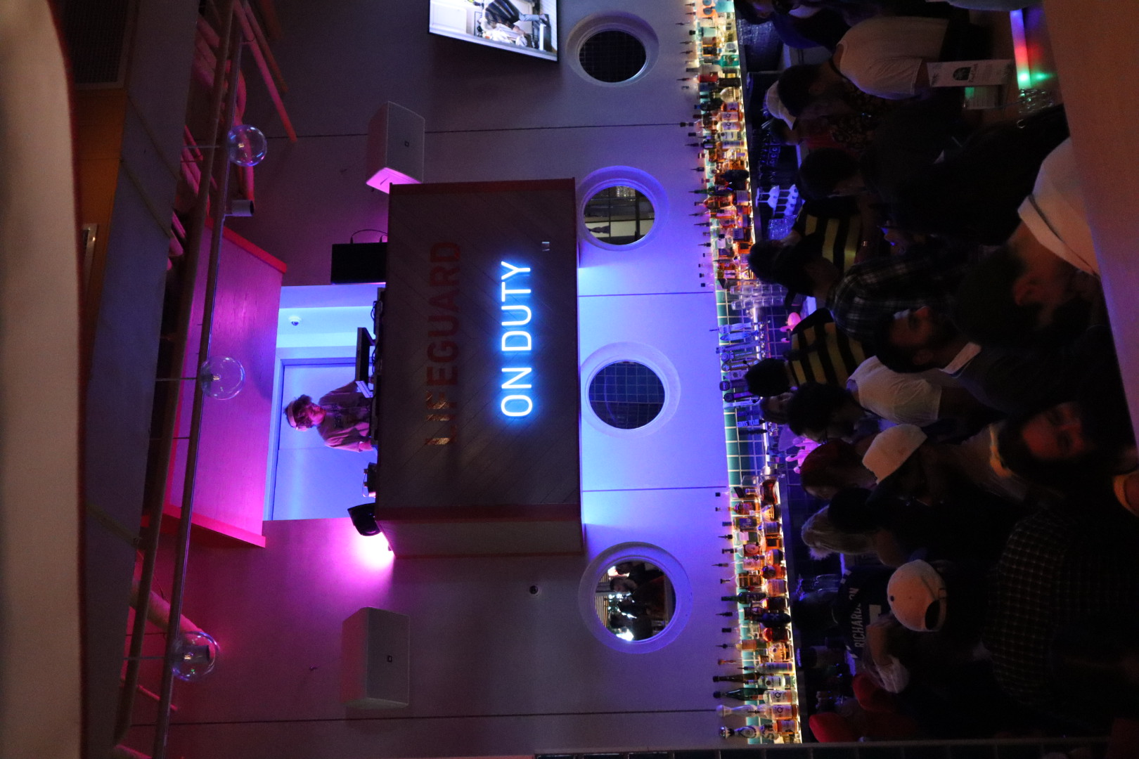 a group of people standing in front of a large screen