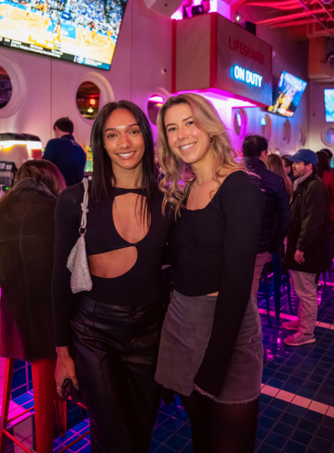 a group of people standing in front of a crowd posing for the camera