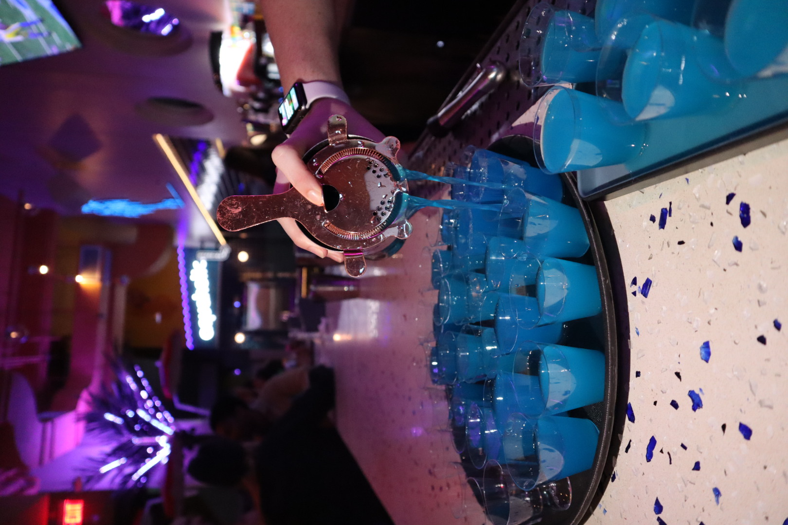 a blue birthday cake with lit candles