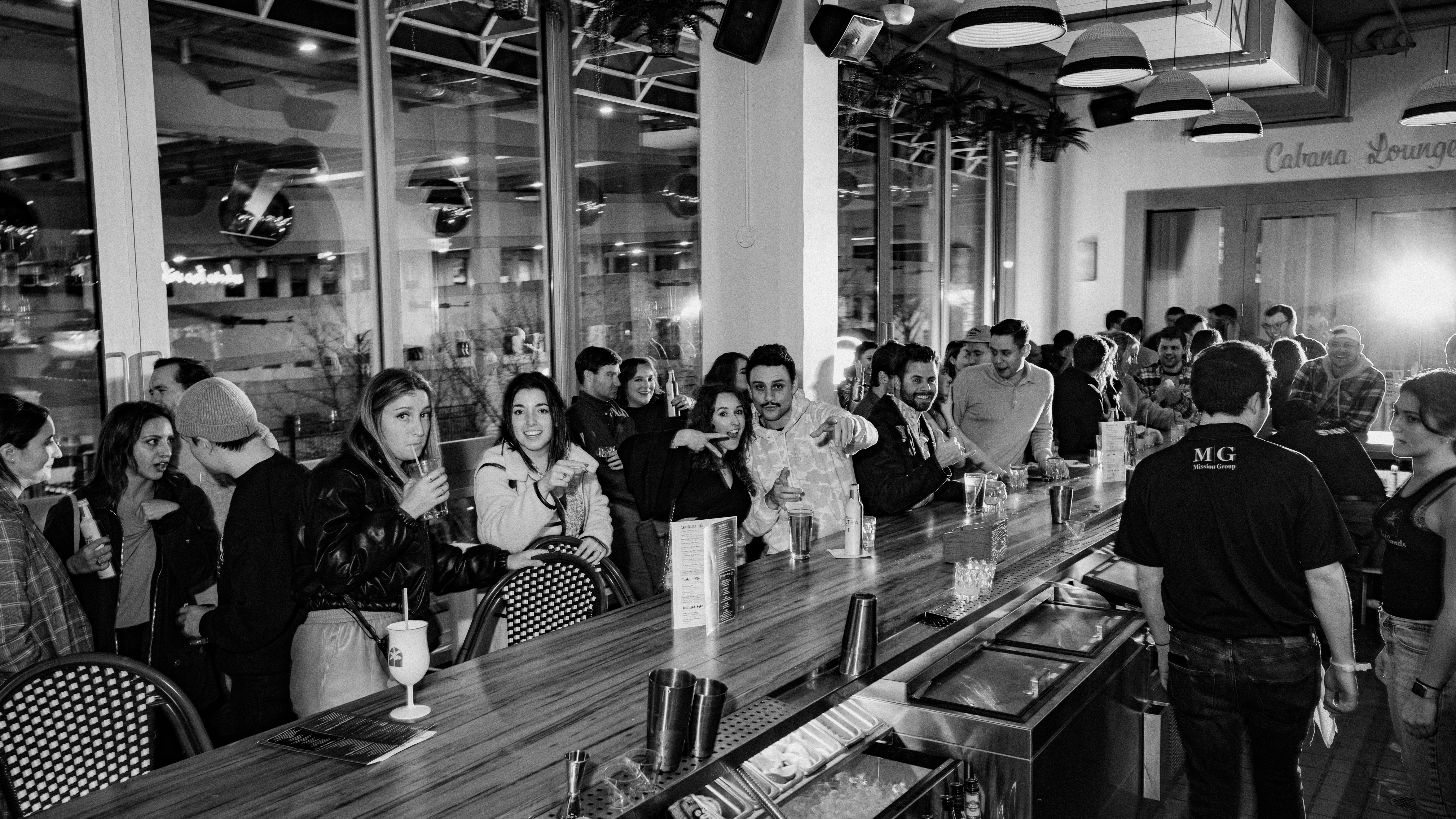 a group of people standing outside of a restaurant