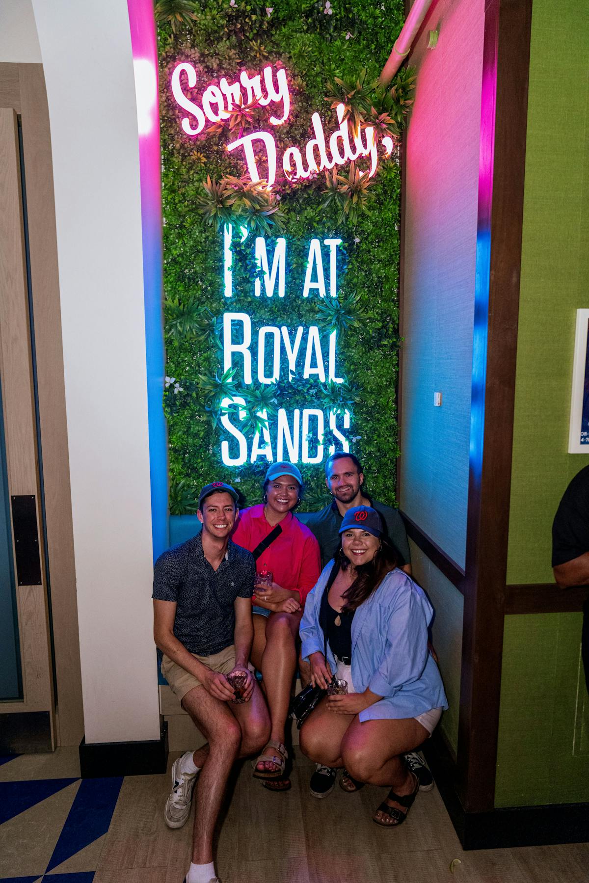 a group of people standing in front of a sign