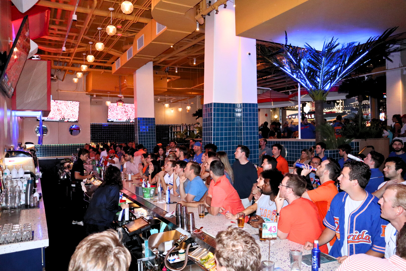 a group of people sitting at a table in front of a crowd