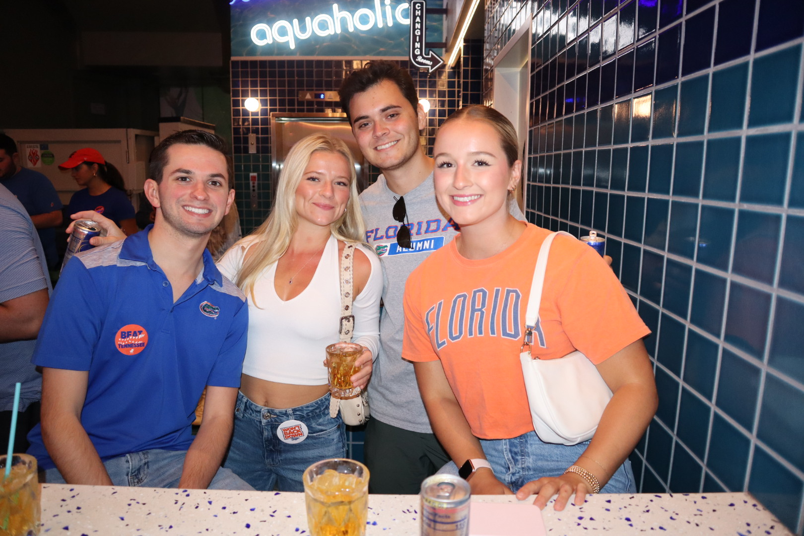 a group of people sitting at a table posing for the camera
