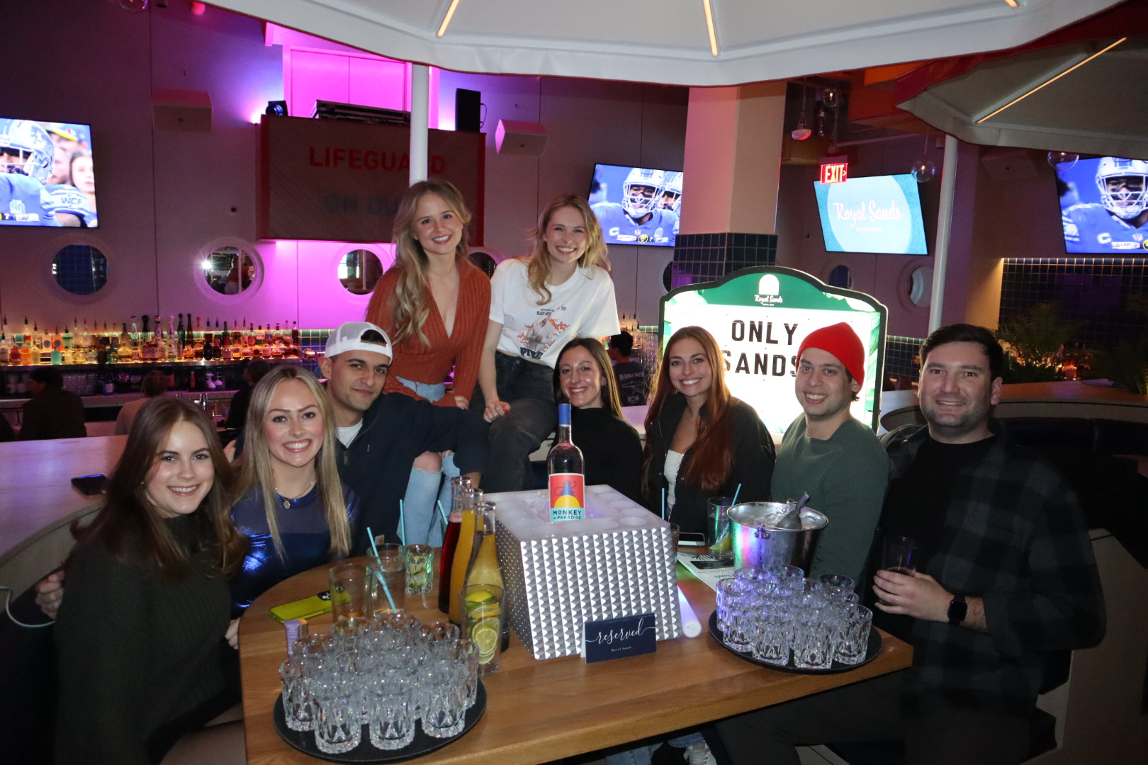 a group of people sitting at a table in front of a store
