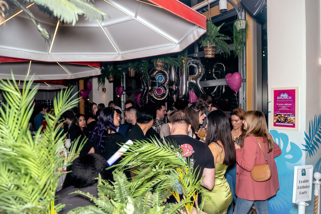 a group of people standing in front of a store